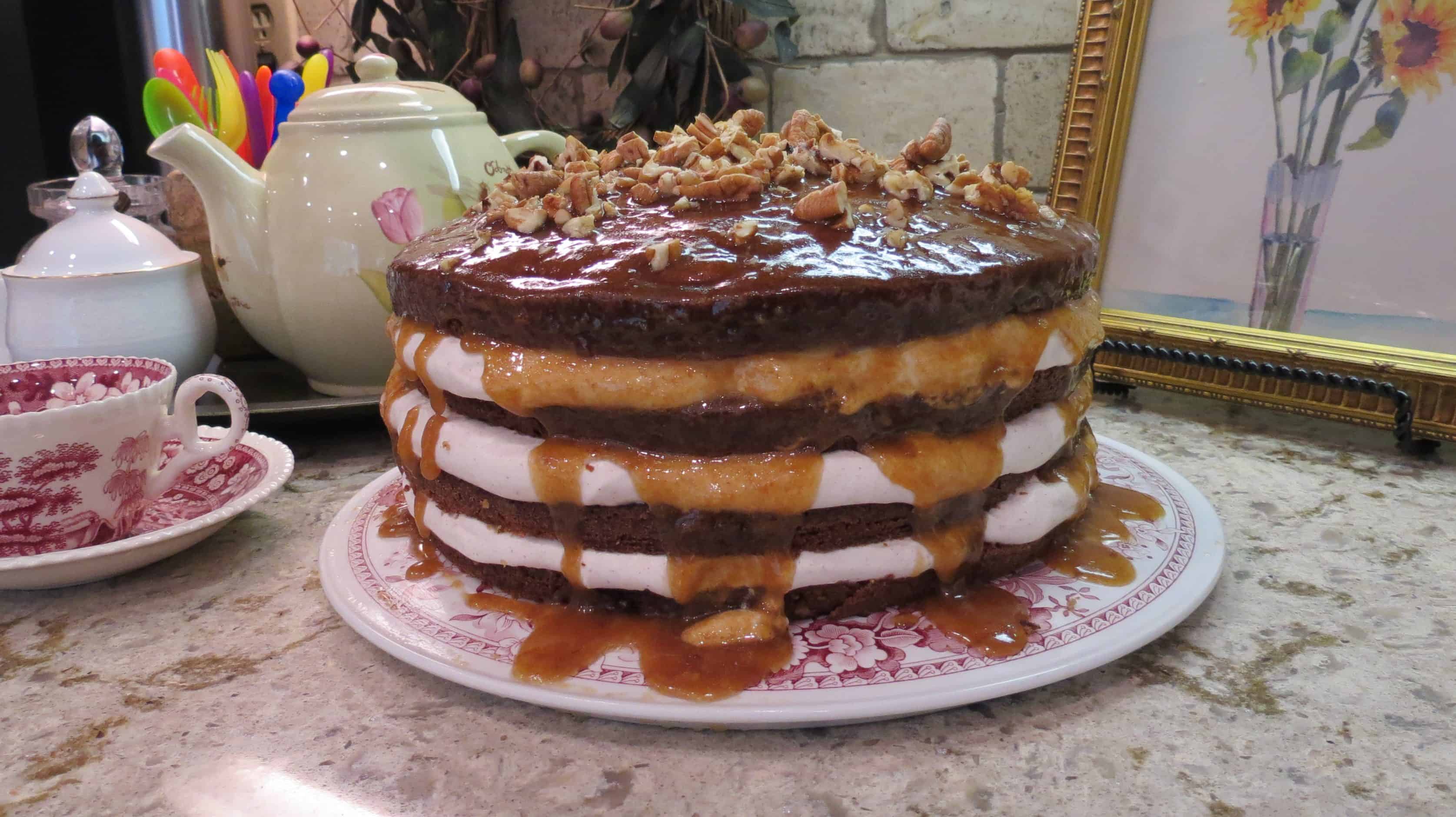 Four layers of fig cake on red toil cake plate.