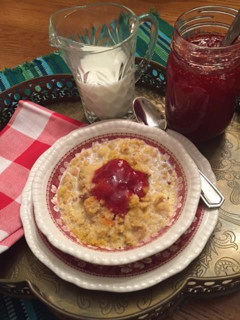 Couche-couche served in a bowl topped with strawberry fig preserves.