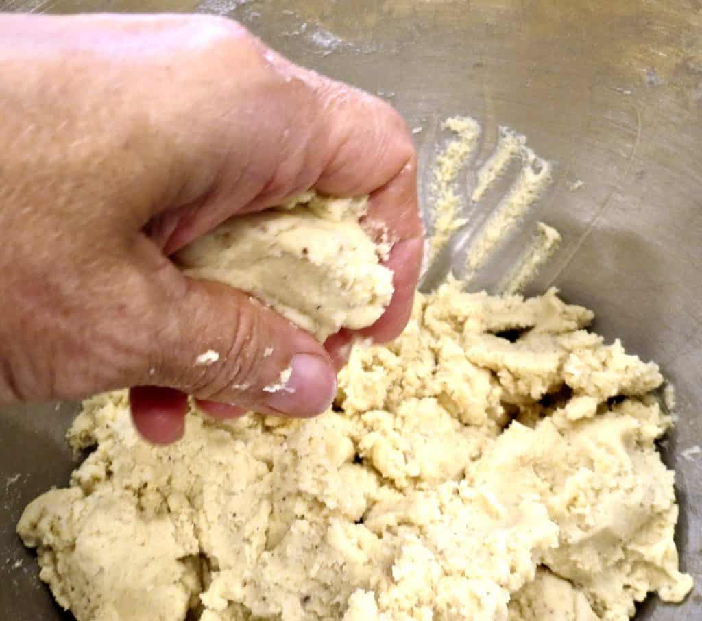 Pinching off dough to roll into Fig Tart Cookies.