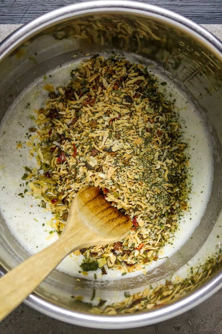 Dried herbs and seasonings in butter in an Instant Pot.