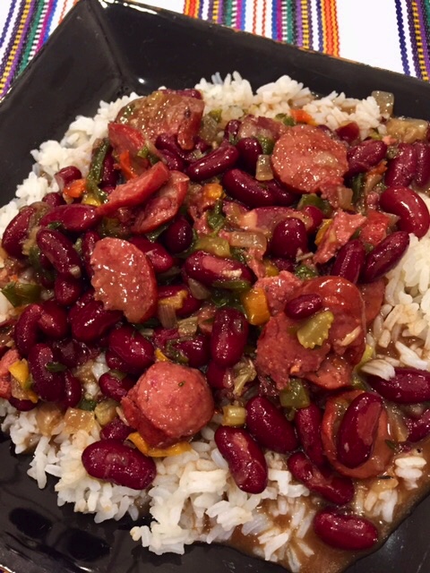 A plateful of white rice topped with "Va Vite" Red Beans And Rice.