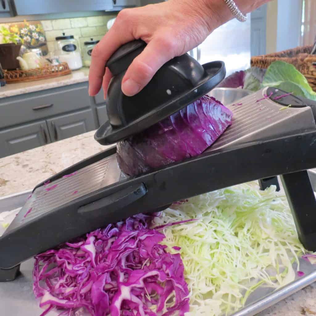 Slicing cabbage with mandolin.