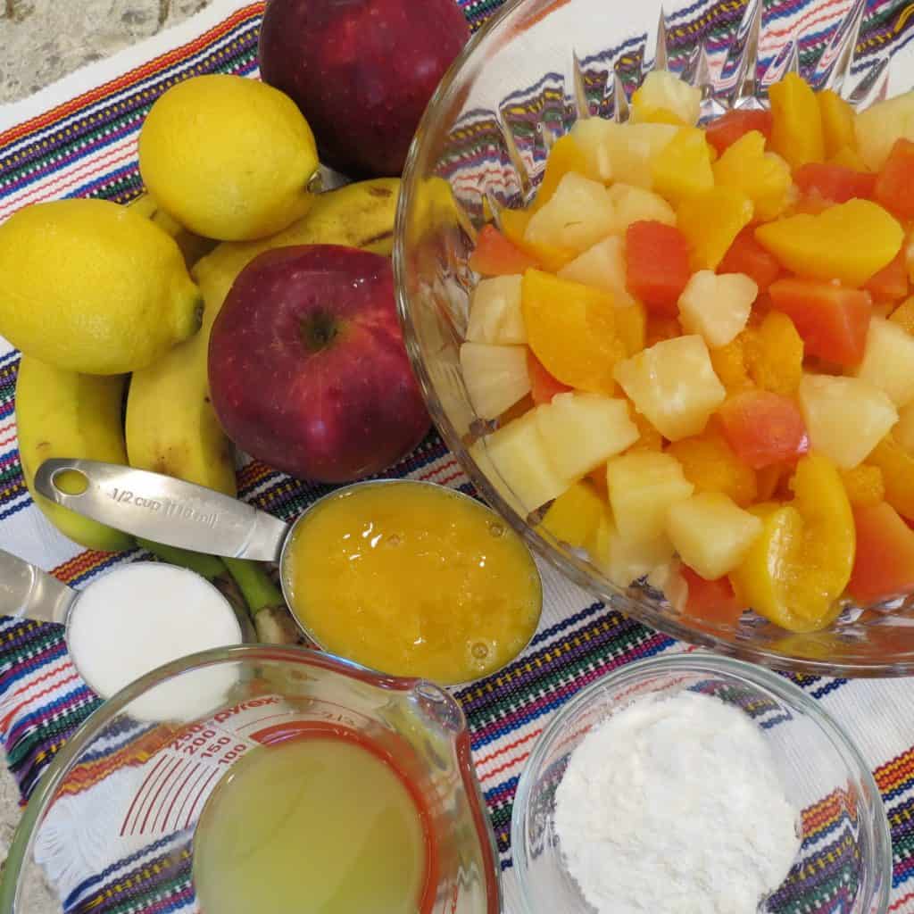 Ingredients of canned and fresh fruit with sauce for Tropical Fruit salad.