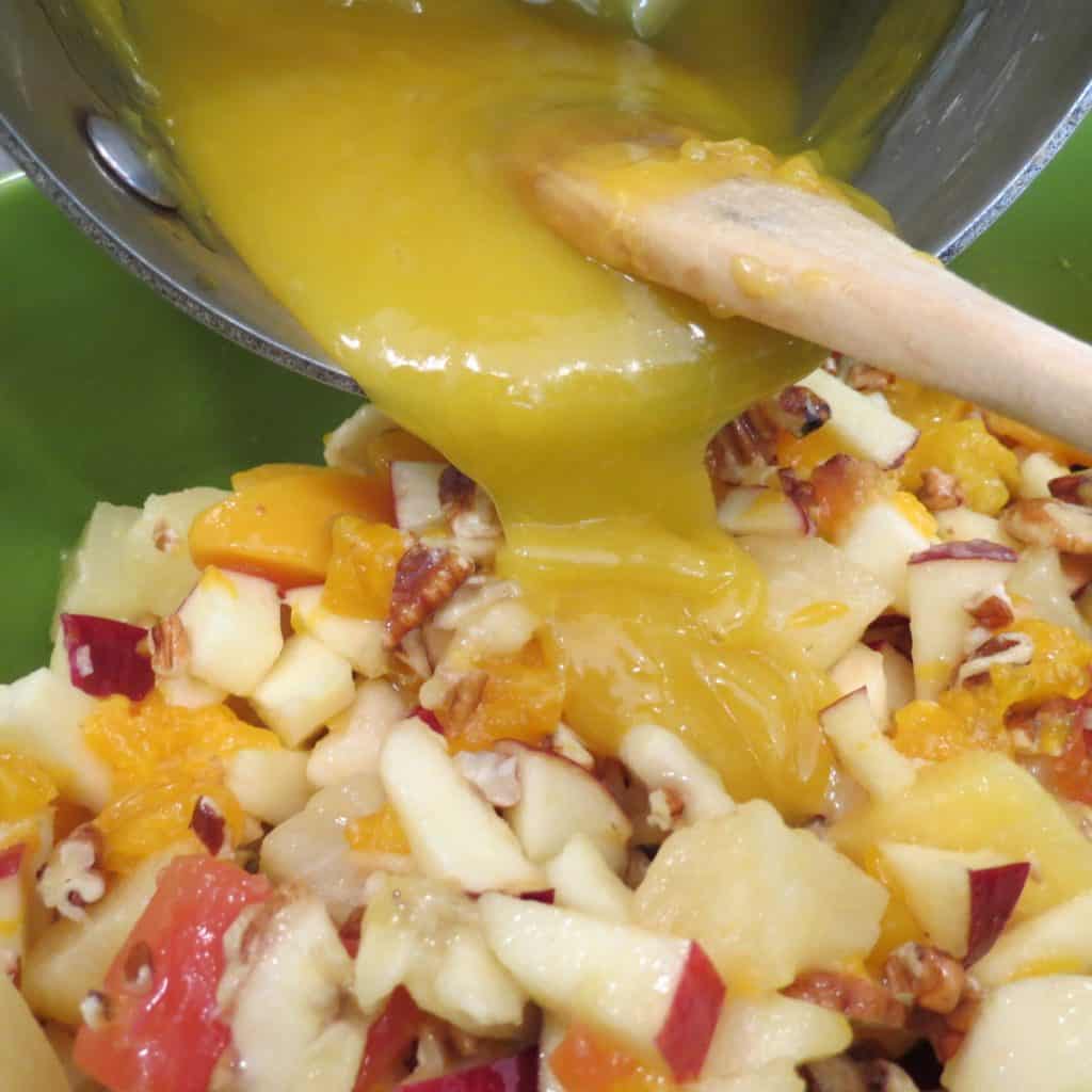 Lemony sauce poured over a bowl of Tropical Fruit Salad mix.