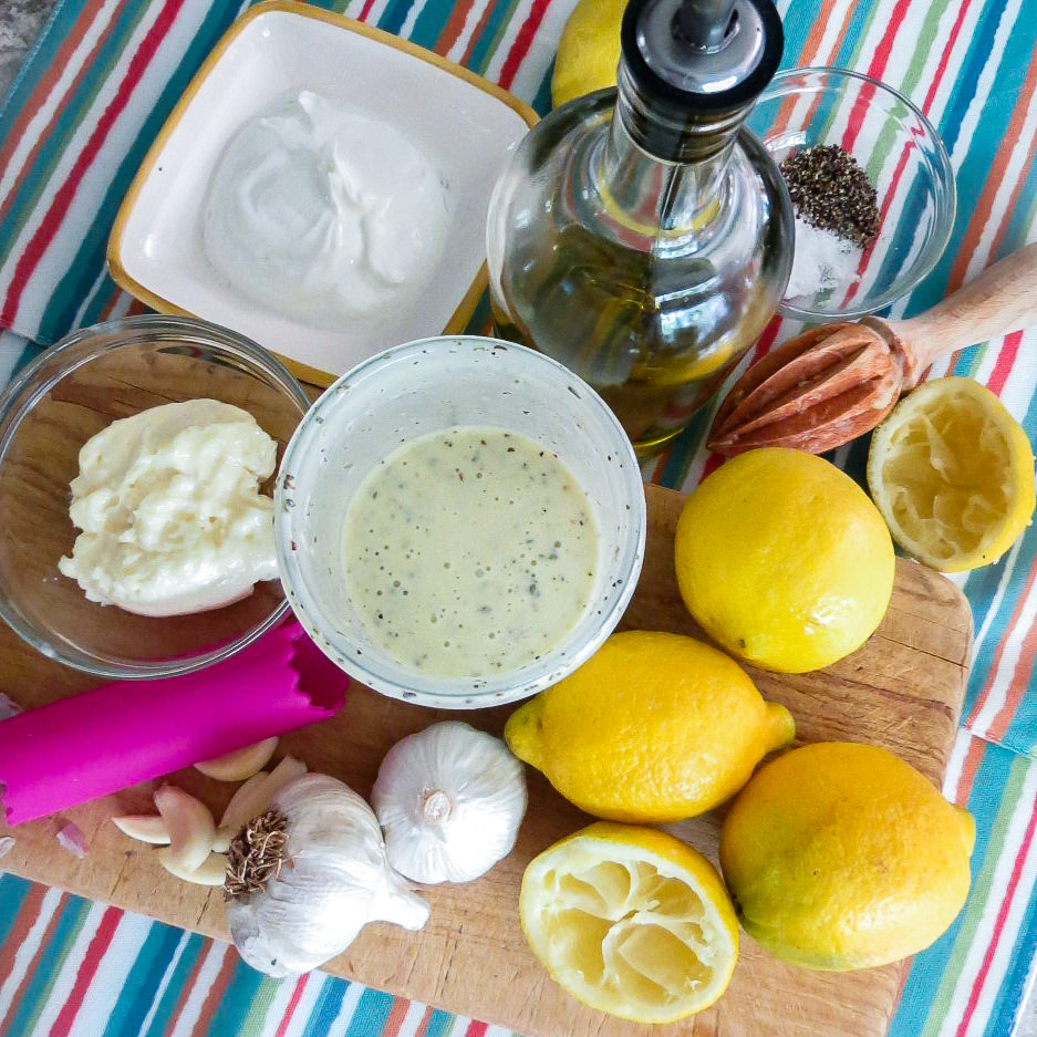 Ingredients for lemon greek yogurt salad dressing on a board for Chicken Salad With Green Peas.