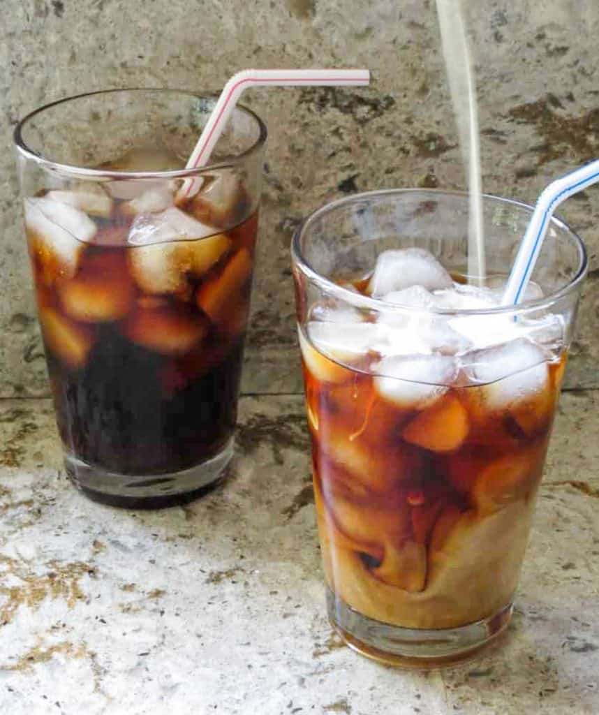 Two glasses of homemade cold brew coffee with straws.