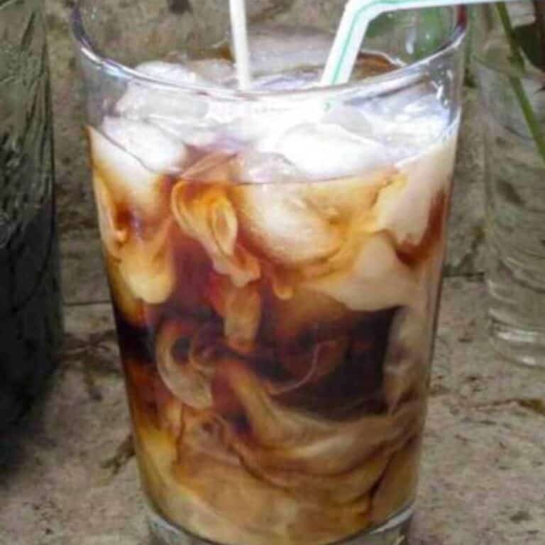 A glass of Homemade Cold Brew Coffee with a straw.