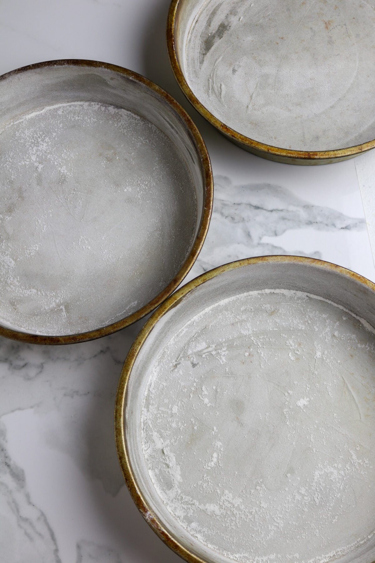 Three prepared cake pans.