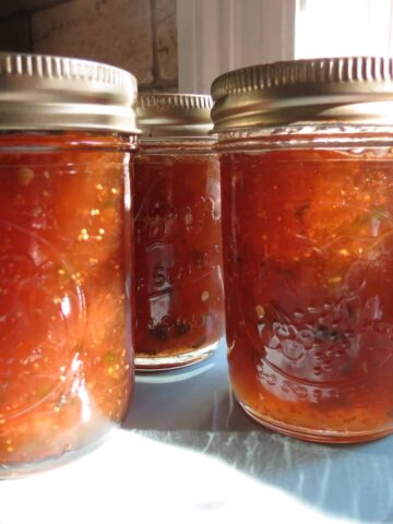 Fig Pepper Jelly in glass jars with lids.
