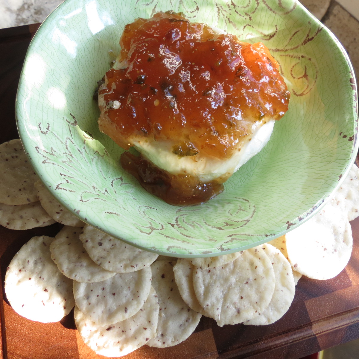 Fig Pepper Jelly on a block of cream cheese.