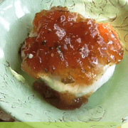Fig Pepper Jelly on a block of cream cheese.