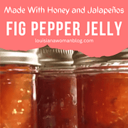 Three canning pint jars of homemade fig pepper jelly.