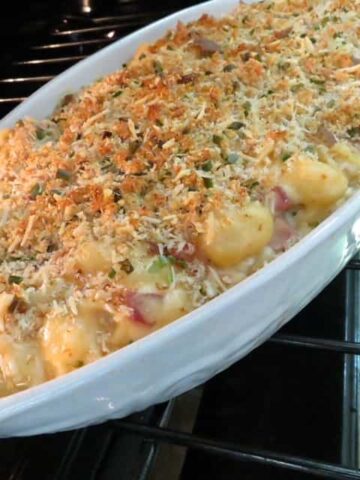 A casserole dish of Tasso Macaroni and Cheese in the oven.