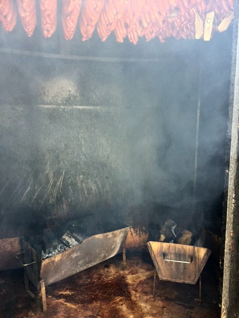 Troughs full of smoldering wood is used to smoke the meat.
