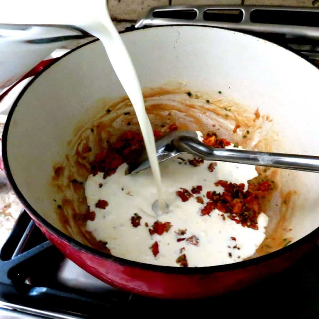 Milk poured into pan of roux.