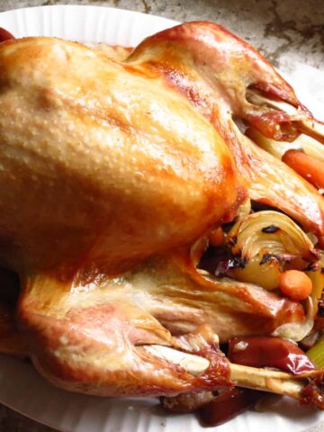 A Roasted Turkey Seasoned In A Brine on a platter.