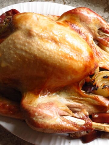 A Roasted Turkey Seasoned In A Brine on a platter.