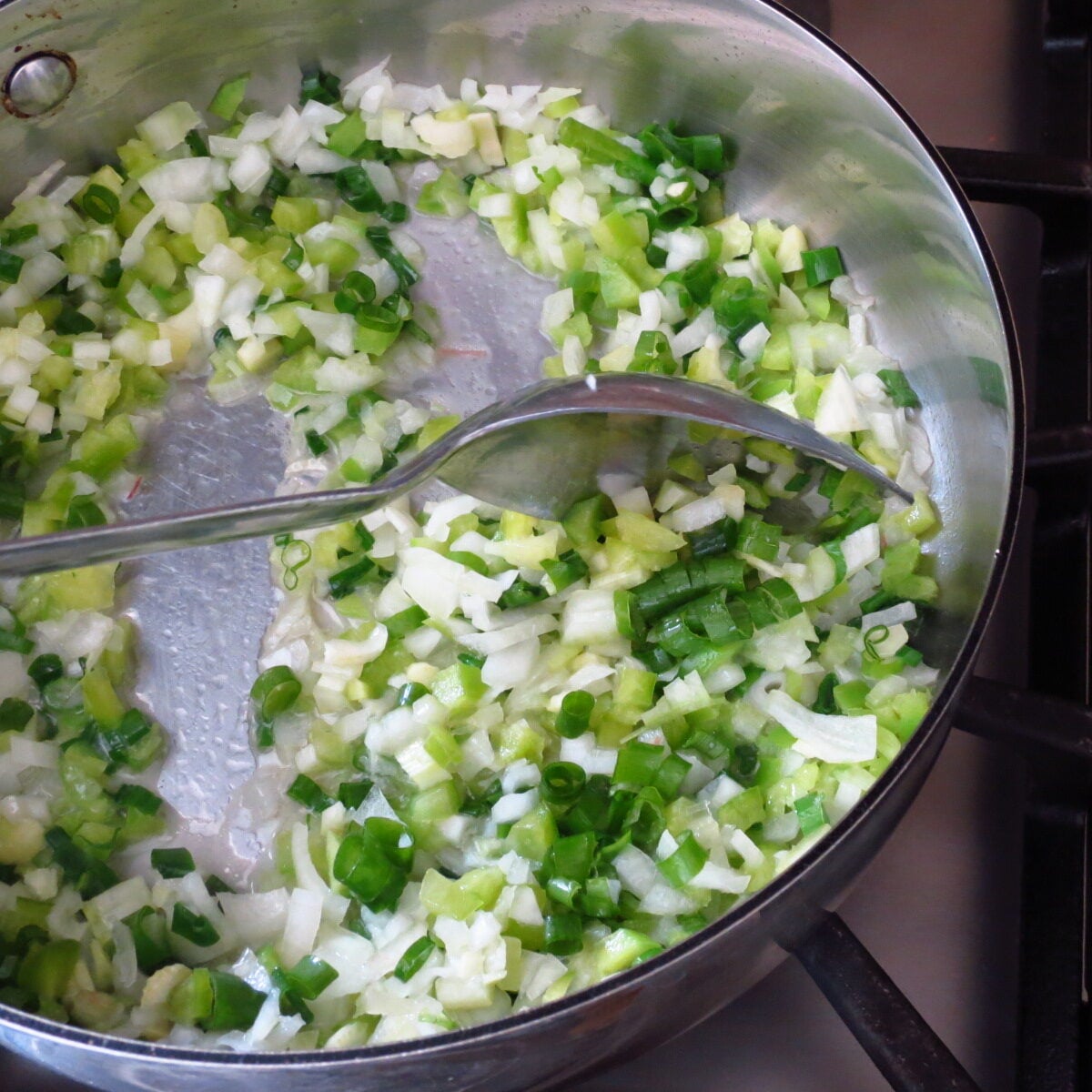 A pan of sautéed onions, celery, and green peppers.