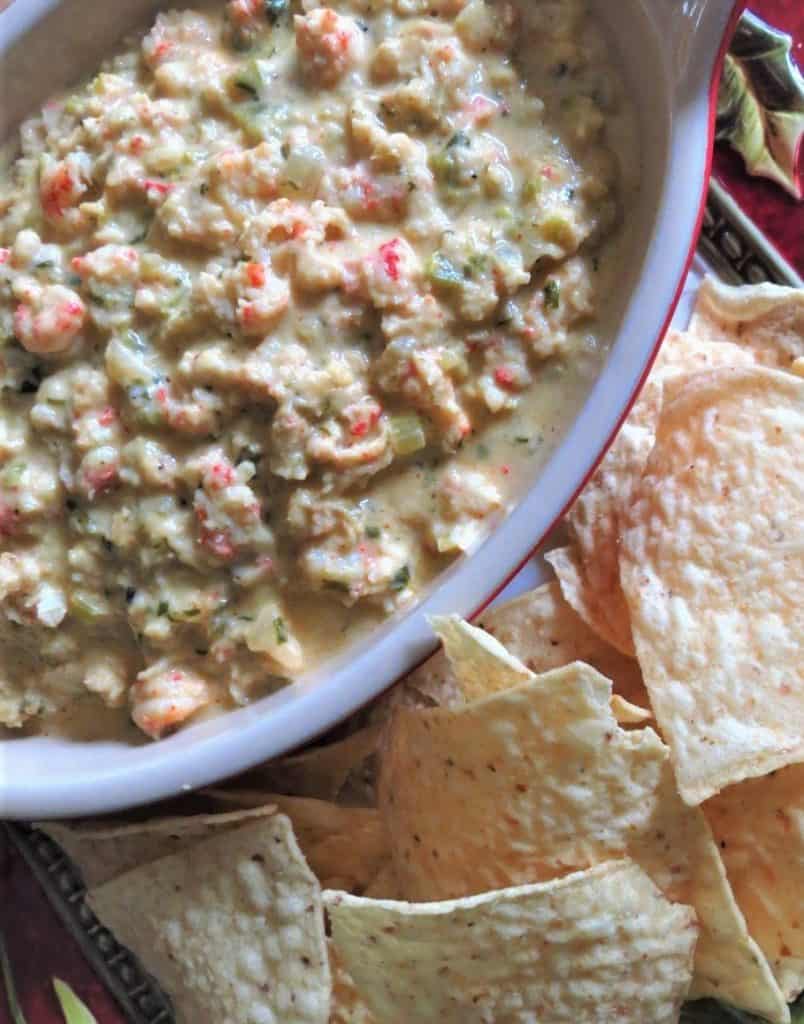 A bowl of Chunky Cheesy Creamy Crawfish Dip with tortilla chips for Mardi Gras Food Recipes.