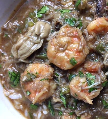 Close-up of oysters and shrimp in a bowl of seafood Gumbo