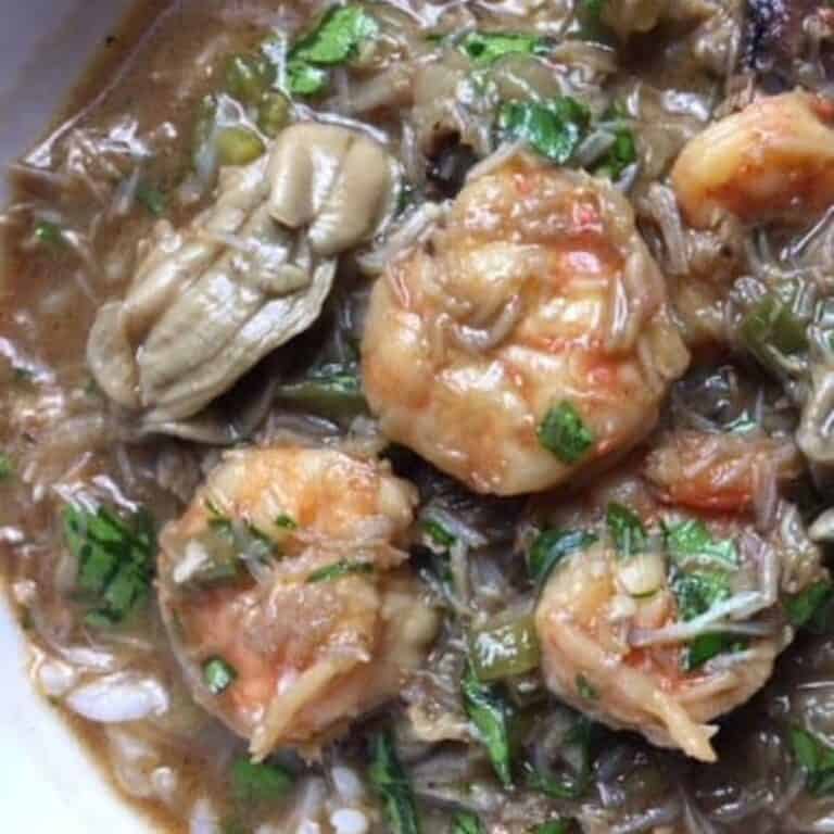 A bowl full of Seafood Gumbo with oysters, shrimp, and crabmeat.