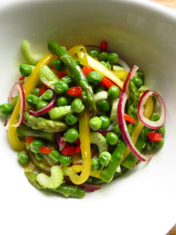 My Mardi Gras Salad is a tossed salad of peas, asparagus, onions, and peppers.