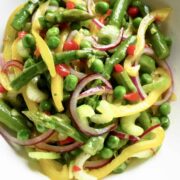 My Mardi Gras Salad is a tossed salad of peas, asparagus, onions, and peppers.