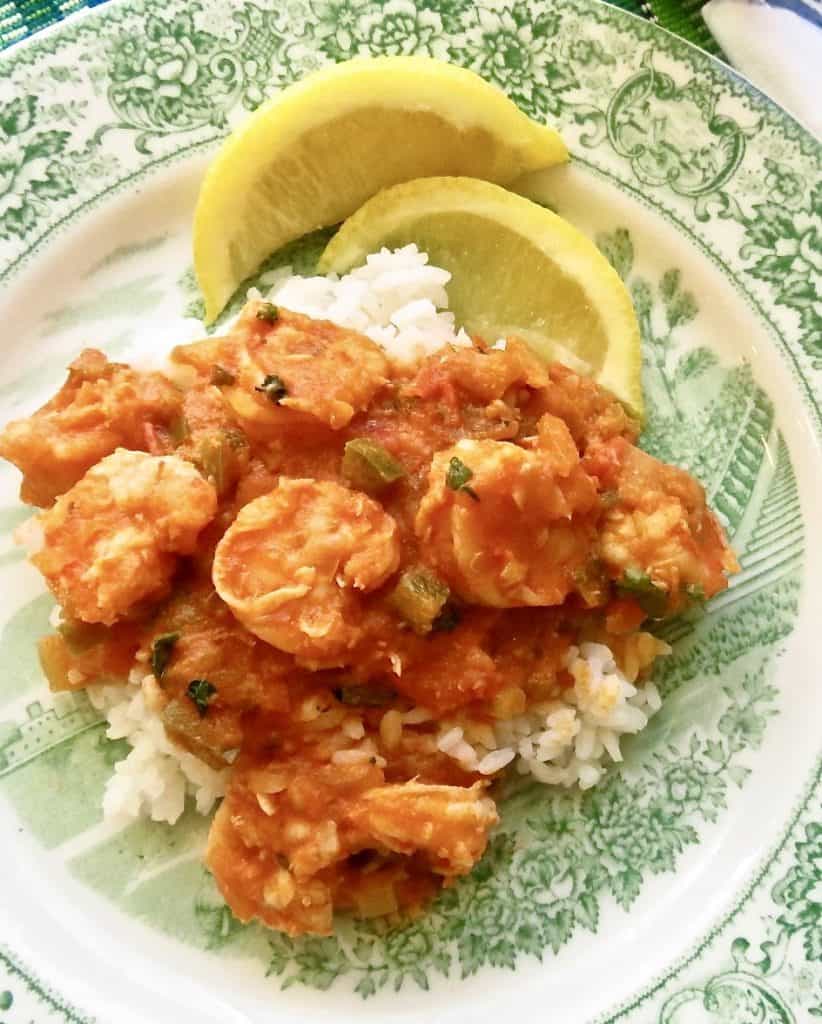 Shrimp creole on a bed of white rice with lemon for garnish