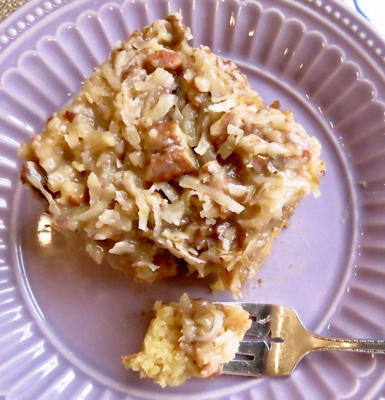 A piece of Cajun Cake on a purple plate and a bite-sized piece on a fork.