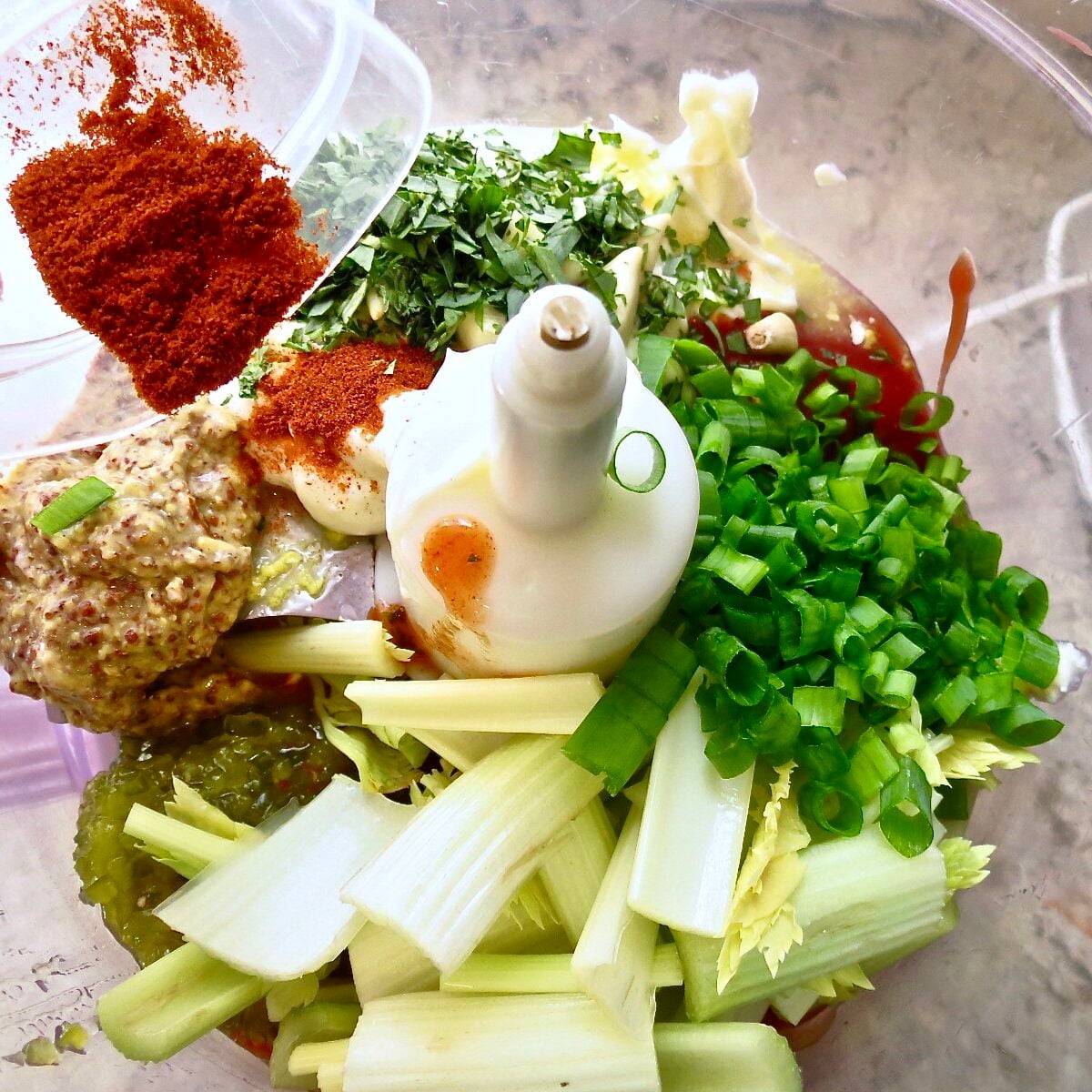 Ingredients for remoulade saucein a food processor.
