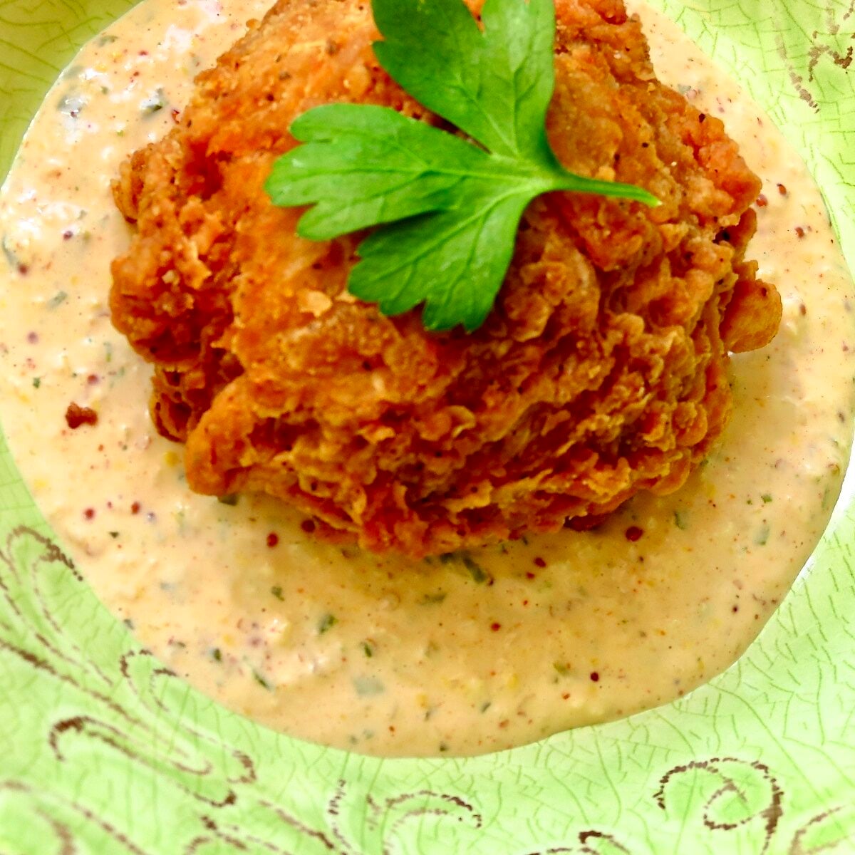 A boudin ball sitting in a dish of a cream sauce.