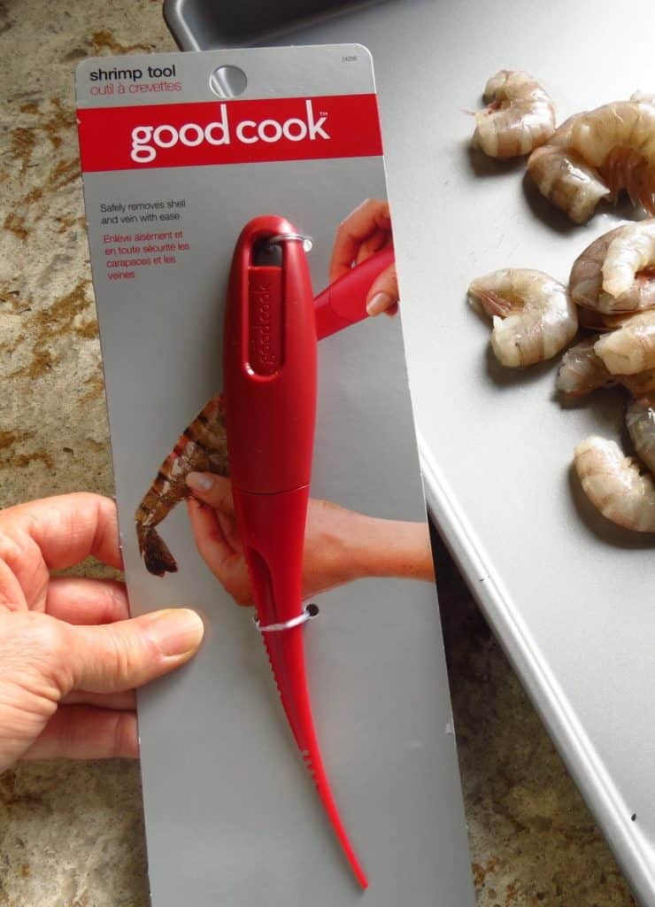 Close up of shrimp tool with unpeeled shrimp in background