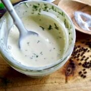 homemade ranch dressing in a jar with a spoon.