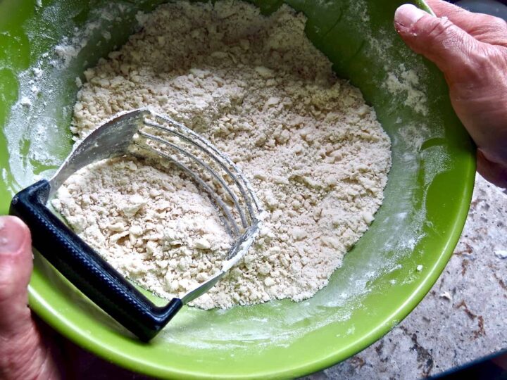 Dough cutter cutting shortening into flour for Chicken Pot Pie.