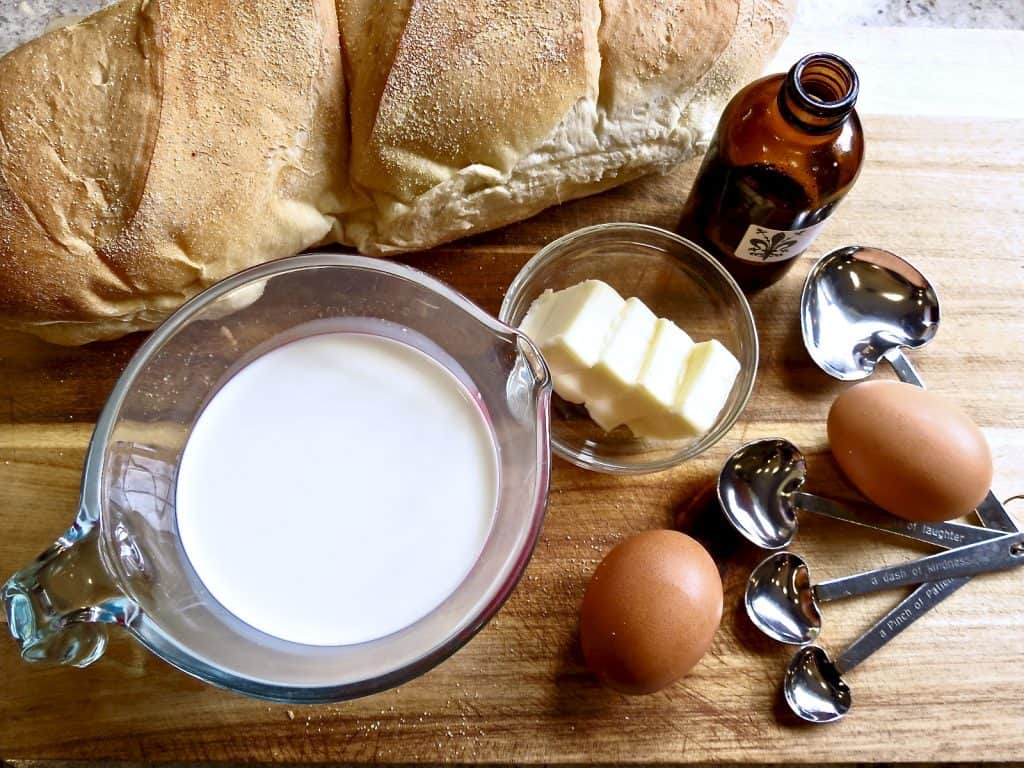 Ingredients for French toast on wooden board.