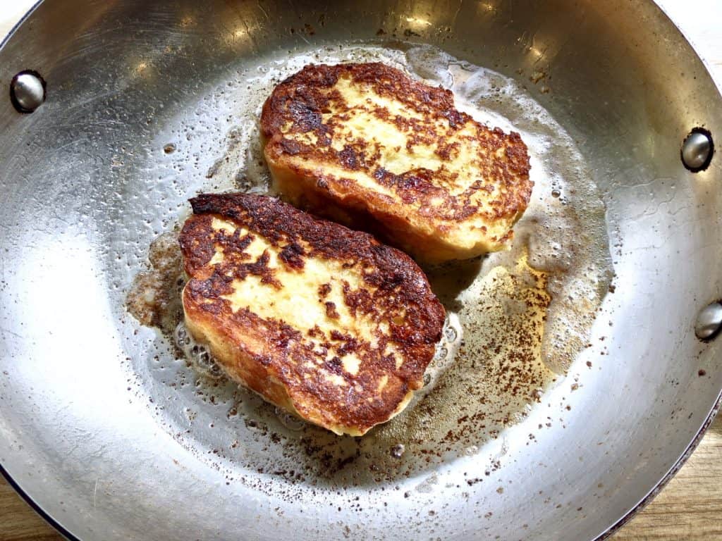 Browned French toast in pan.