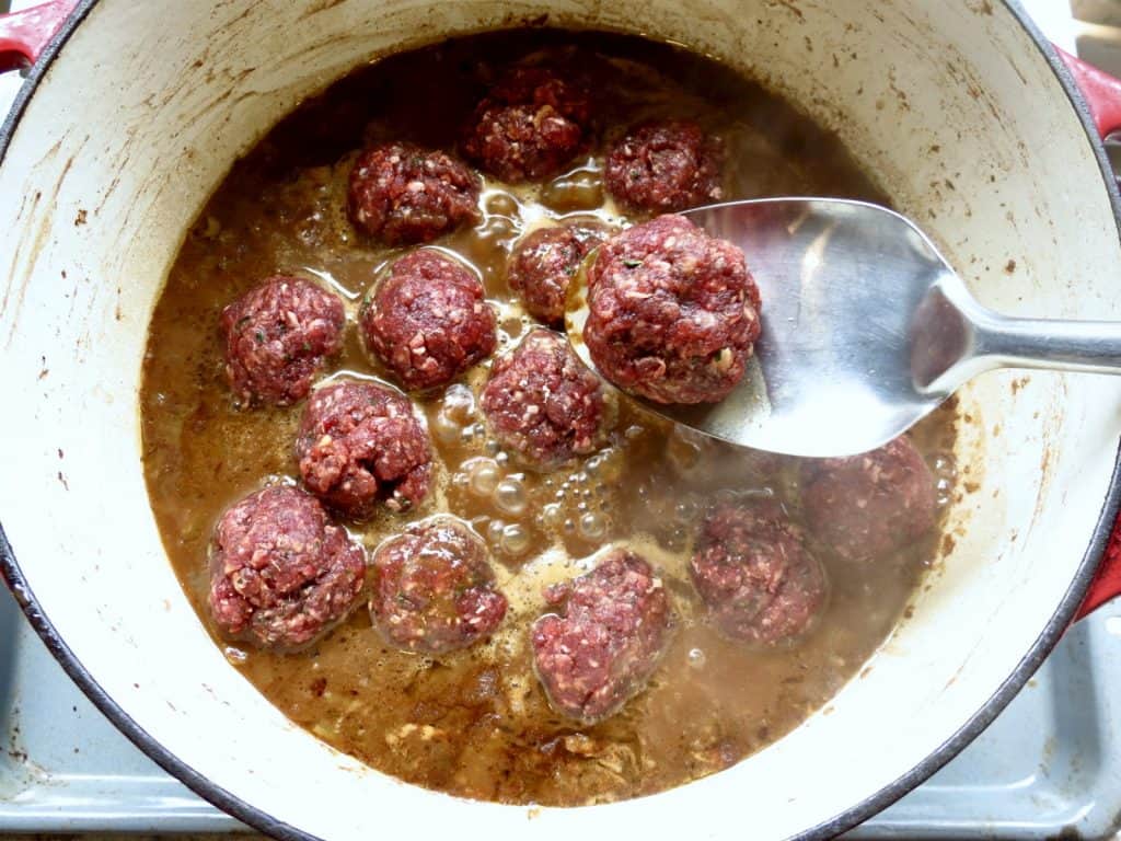 Pot of meatballs in gravy of Comforting Cajun Meatball Stew.