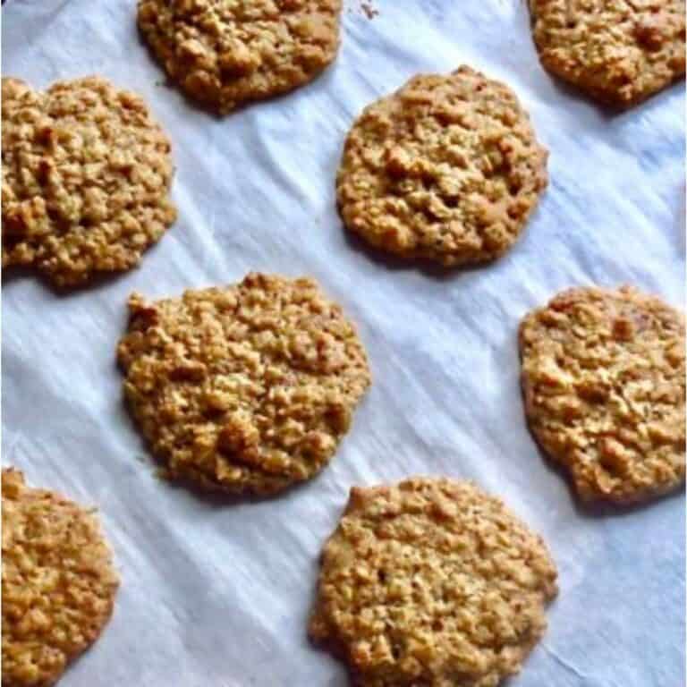 Lunchroom Lady Oatmeal Cookies baked on a cookie sheet lined with parchment paper.