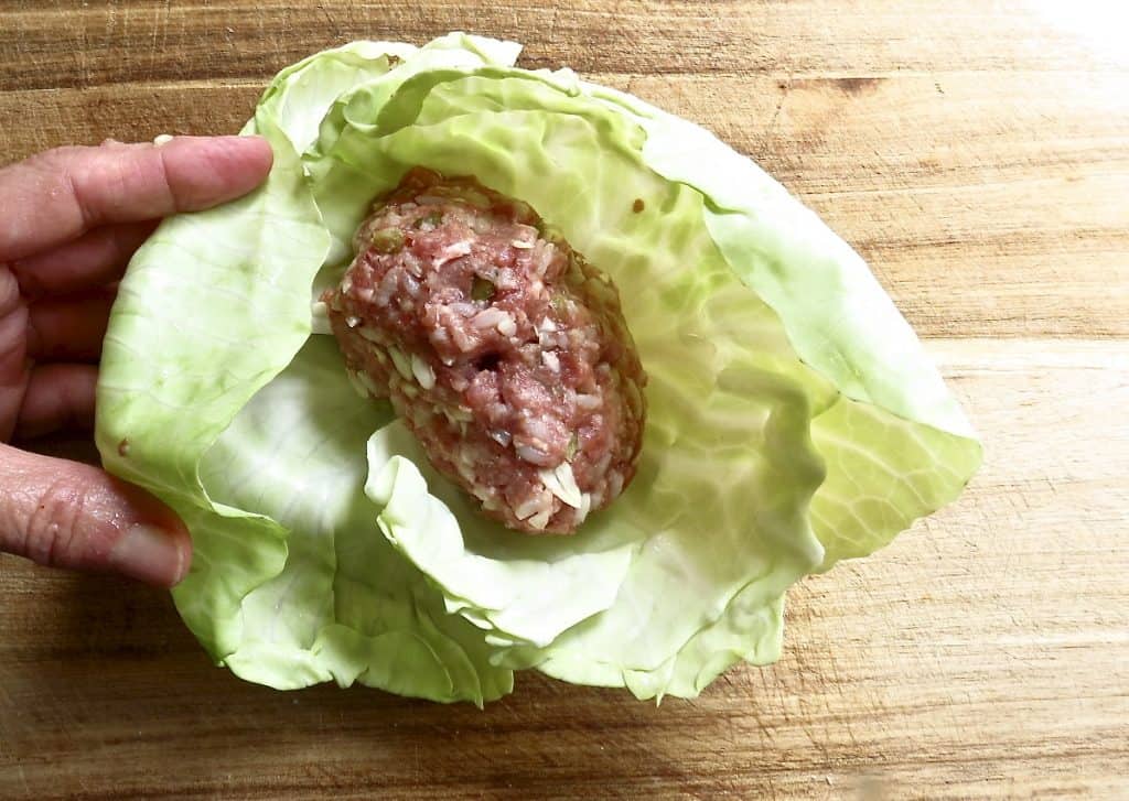Cabbage leaves with cabbage roll meat mixture inside.