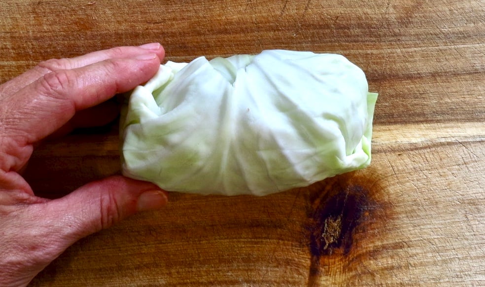 A Cabbage Roll on a wooden board.