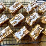 Pumpkin bars with glaze cooling on a rack.