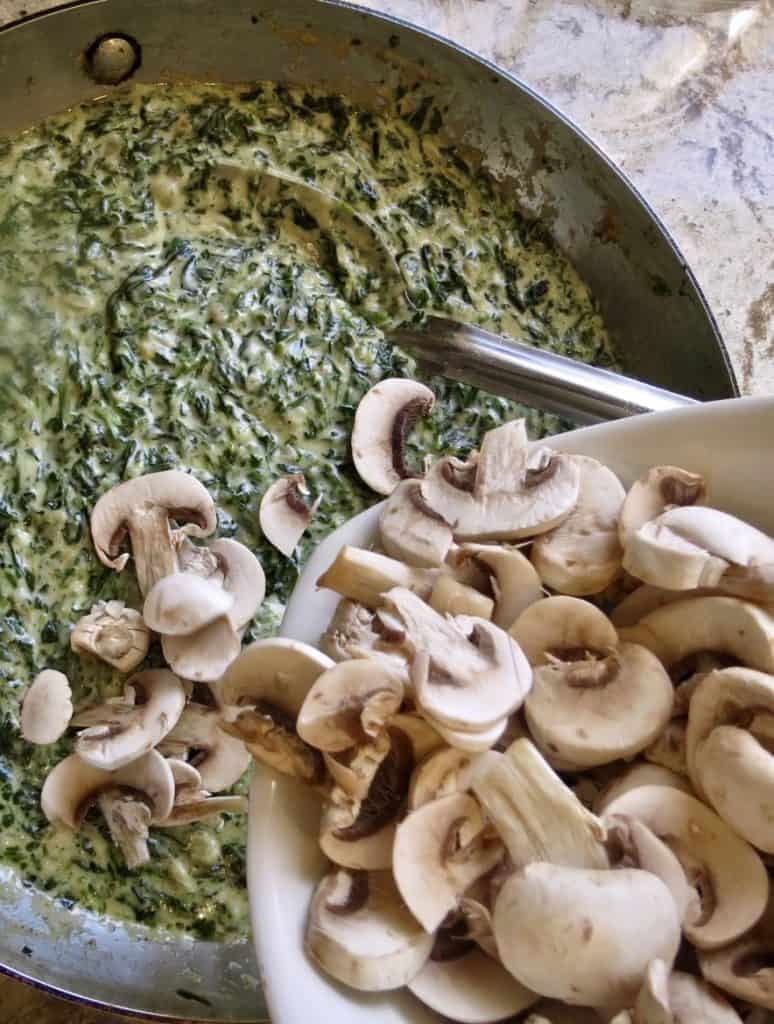 Fresh mushrooms added to saucepan of Creamed Spinach With Mushrooms.