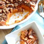 A casserole dish if Sweet Potato Casserole with a smaller dish with some sweet potato casserole in it.