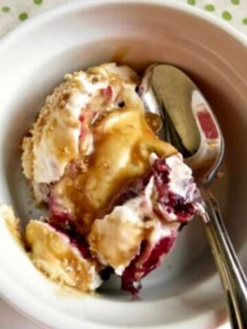 A serving of Easy Pie Trifle Dessert in a white dish with a spoon.