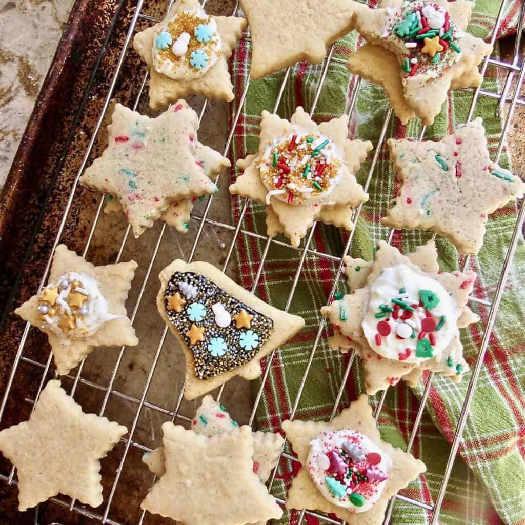 Decorated sugar cookies with brown butter on a cooling rack.