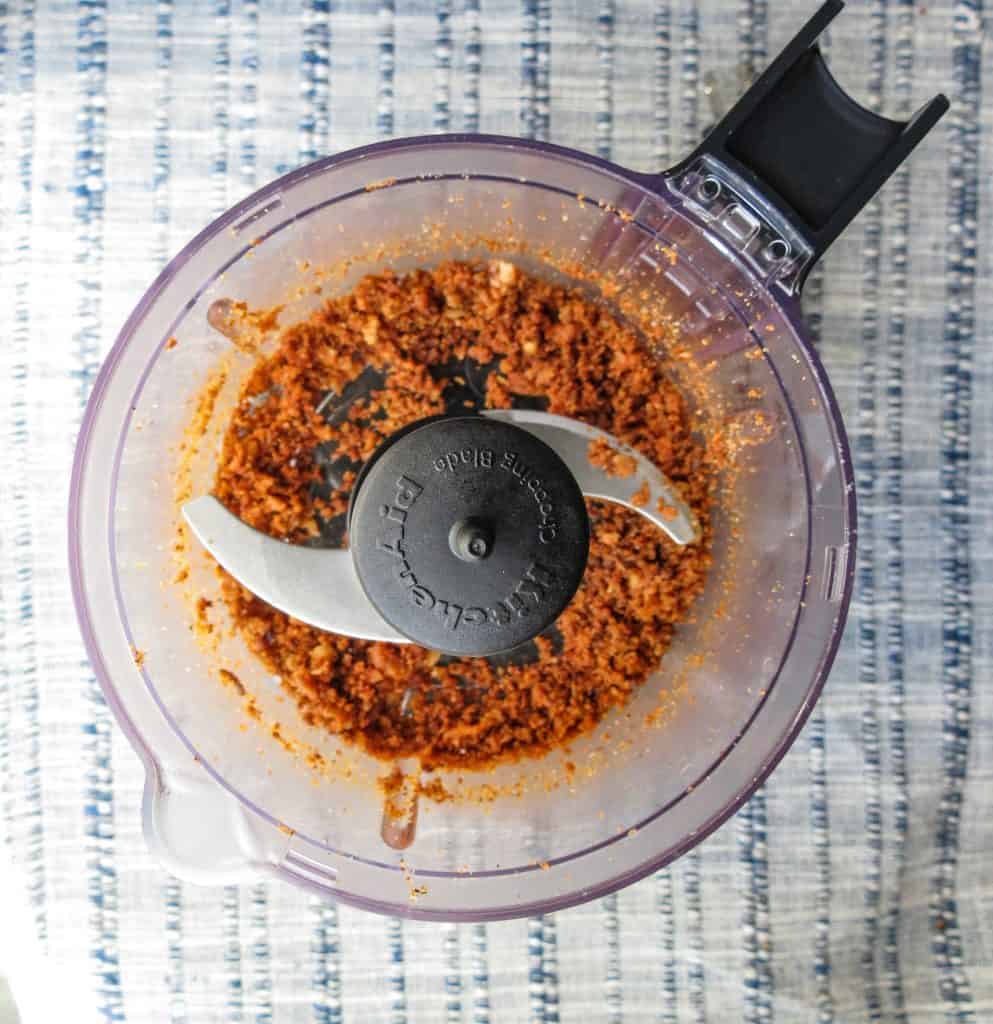 A small food processor with ground Cajun cracklins in it for Fat Bombs.