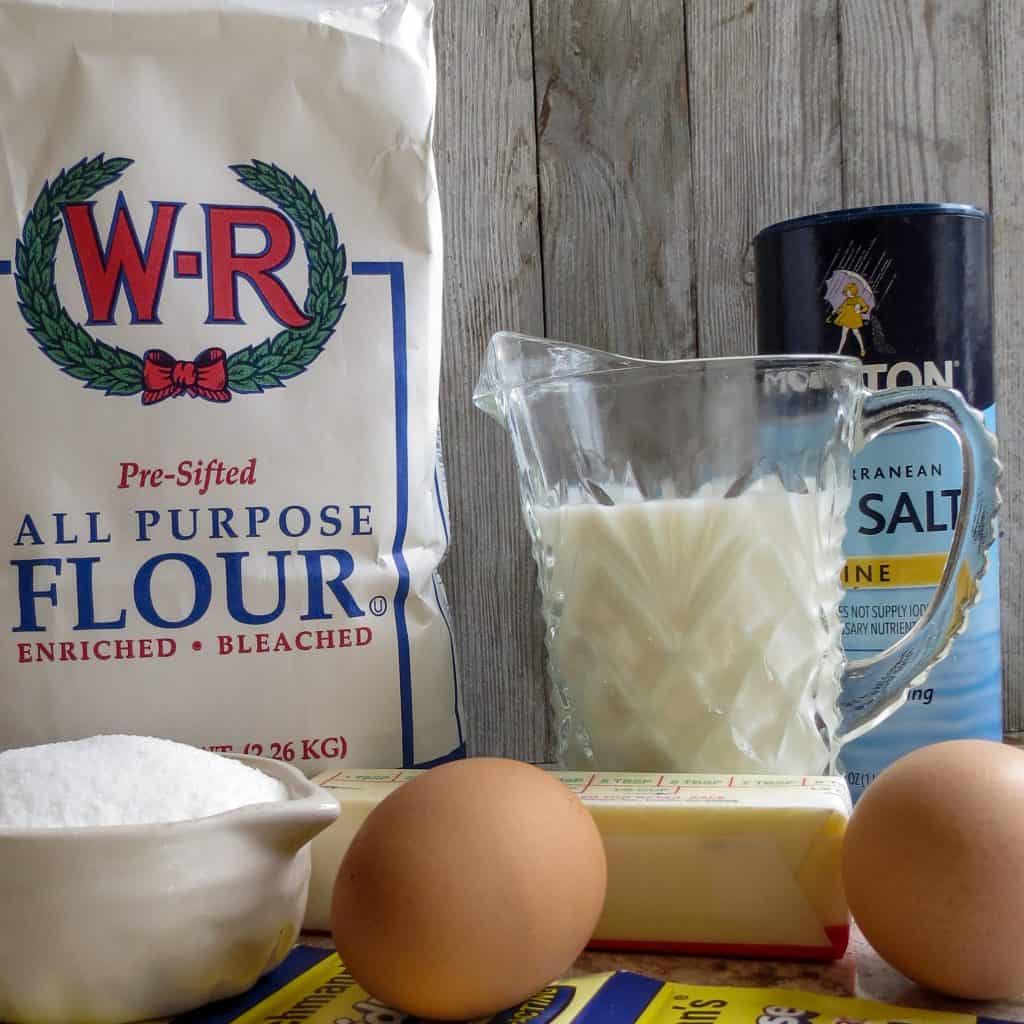 Ingredients of yeast, flour, milk, salt, sugar and butter for Easy No-Knead Bread .
