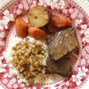A red and white toile plate of rice and gravy, roast, carrots and potato for Rice and Gravy, A Cajun's Staple