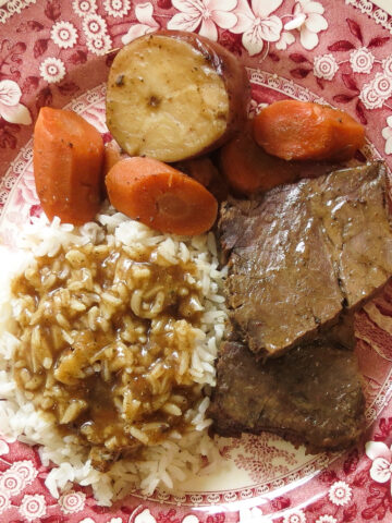 A red and white toile plate of rice and gravy, roast, carrots and potato for Rice and Gravy, A Cajun's Staple