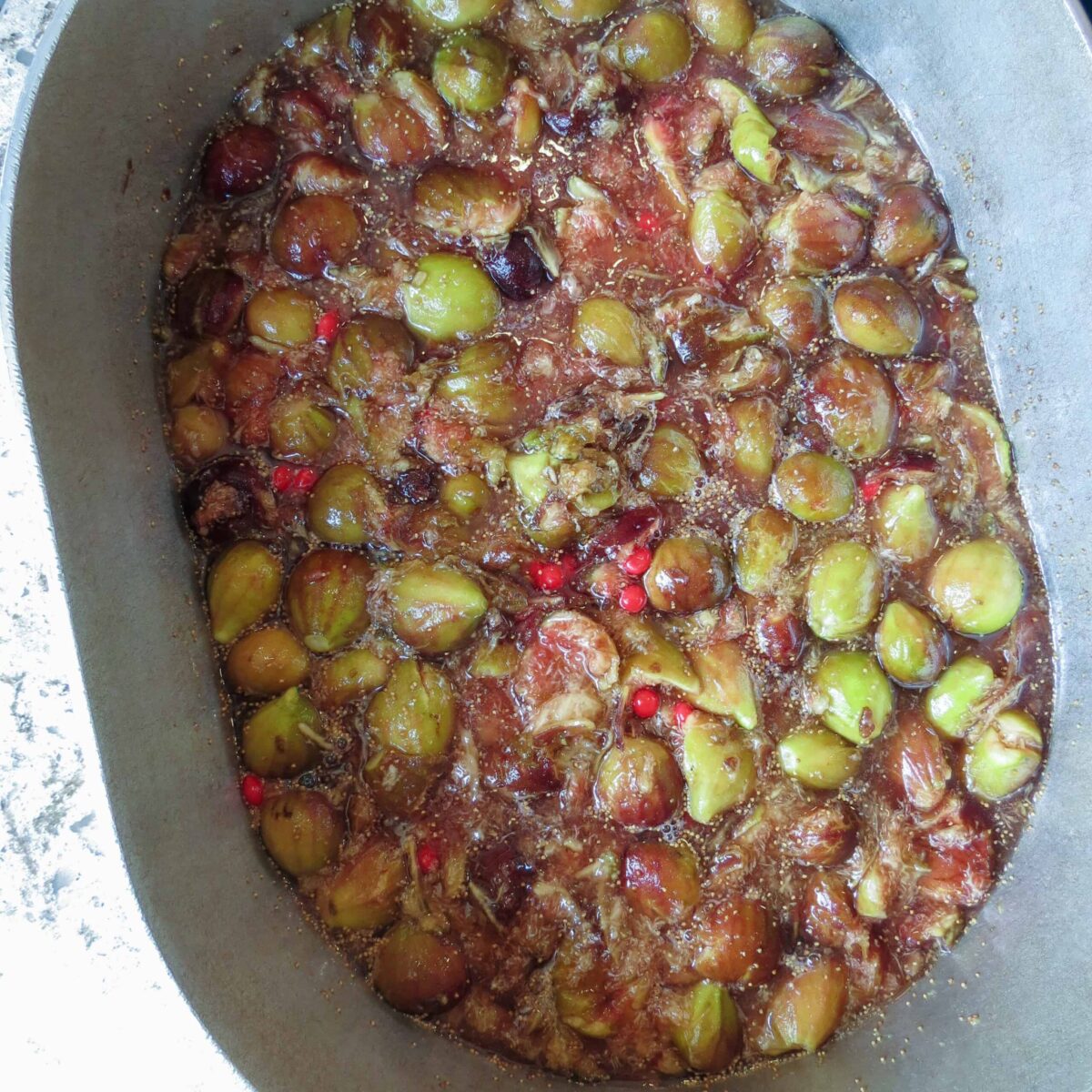 A large pot of crushed figs cooking with red hot candies.